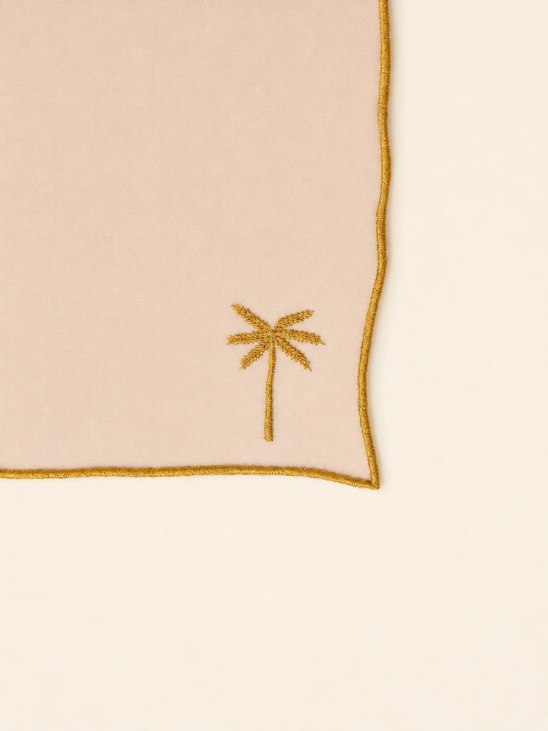 Aurora Scarf with embroidered palm tree design on a beige background