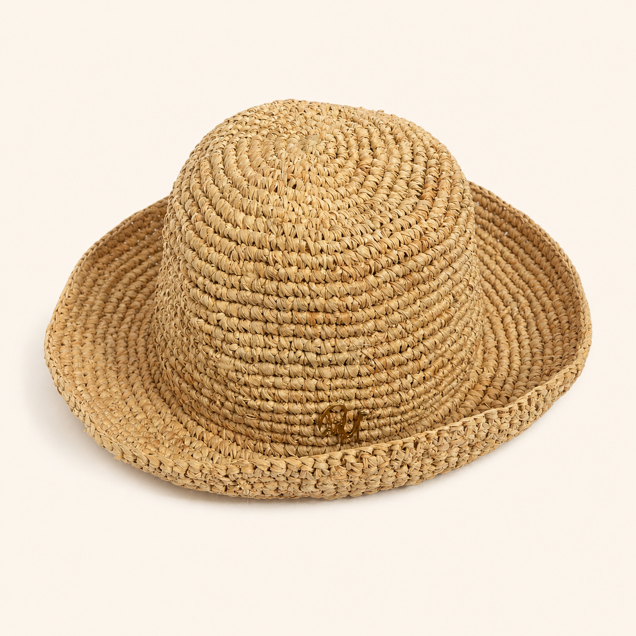 Woven straw hat on a beige background