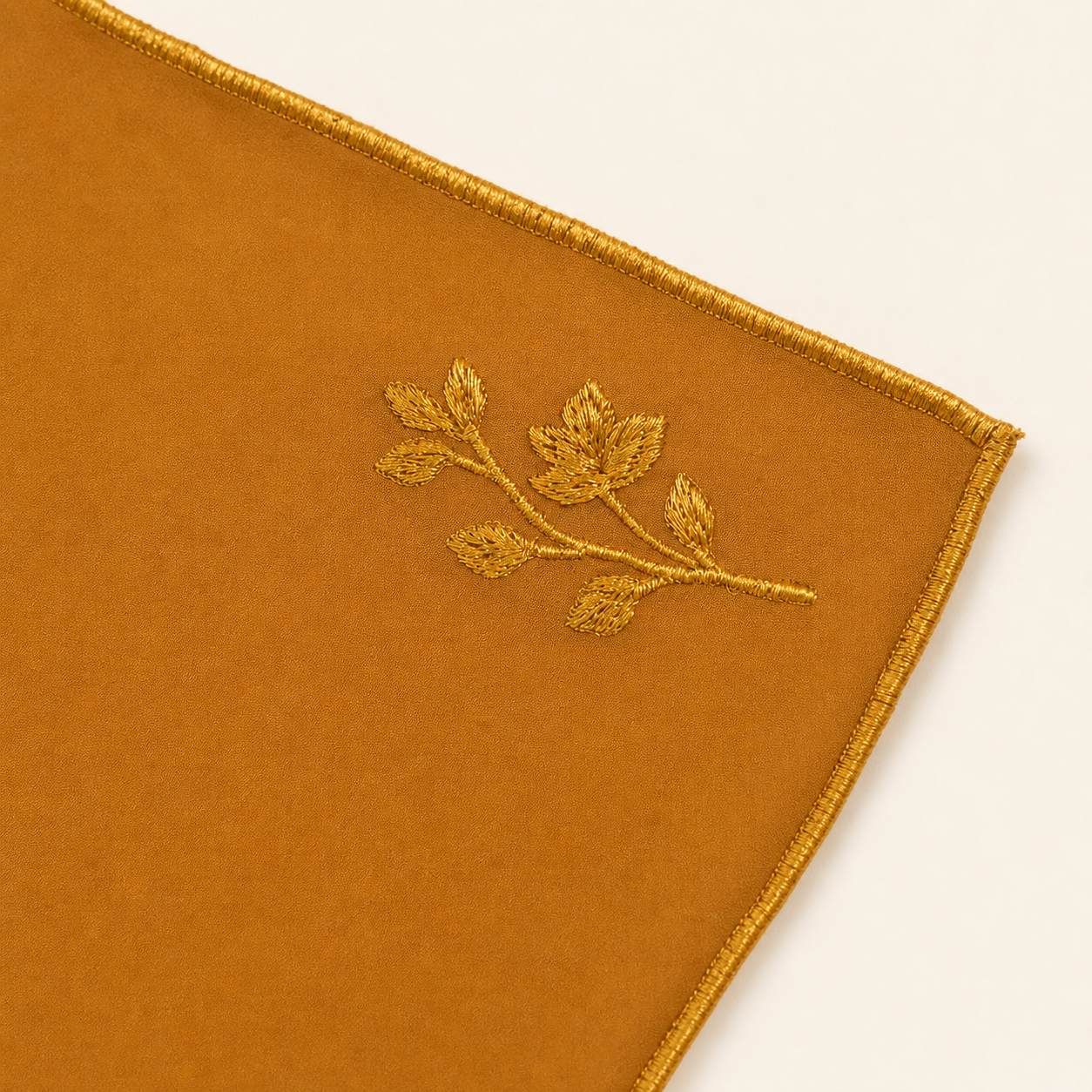 Taupe Scarf with embroidered leaf design on a beige background