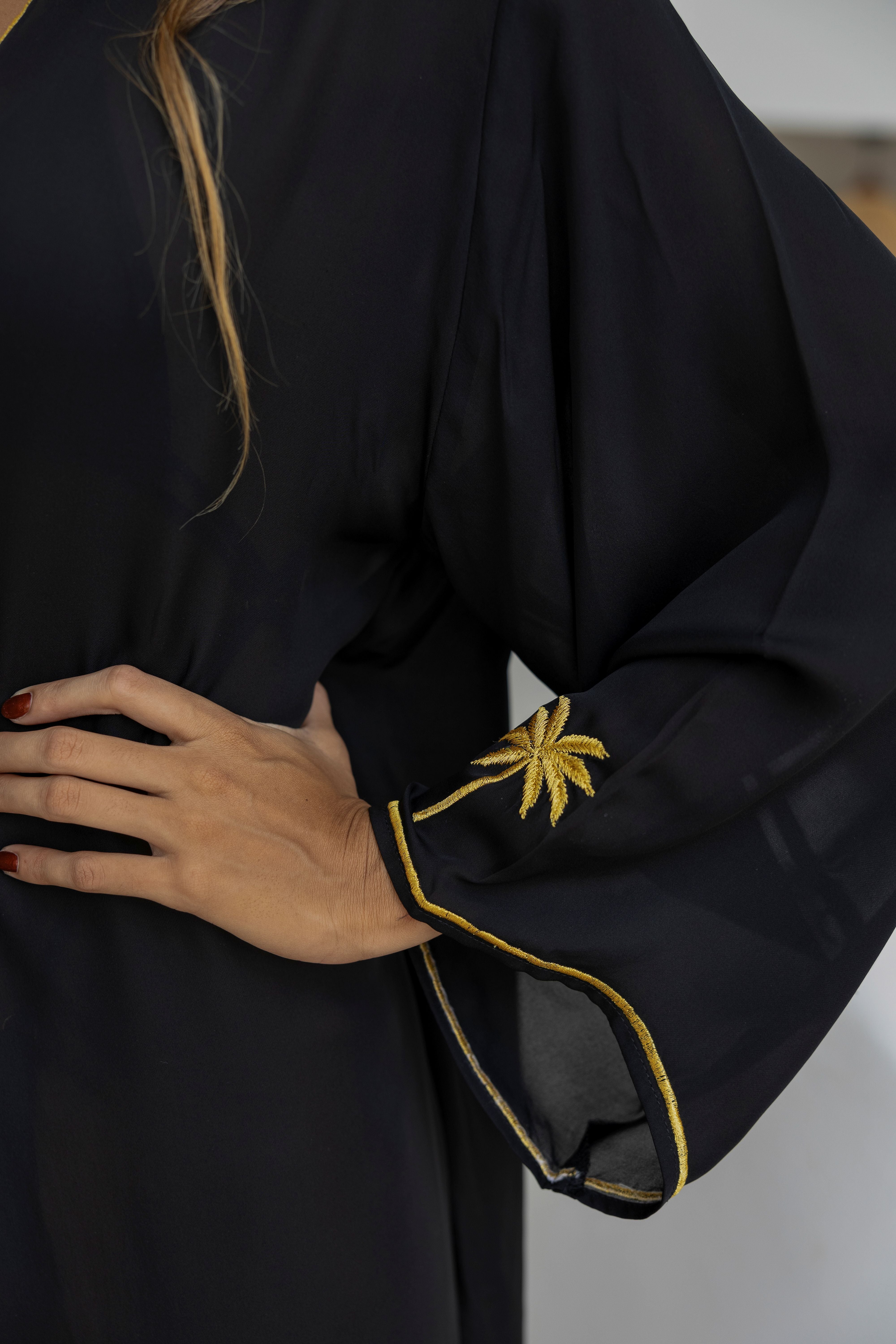 Black garment with yellow trim on a plain background